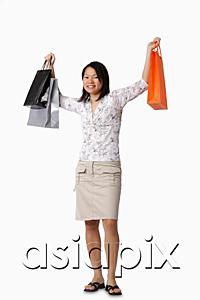 AsiaPix - Young woman carrying shopping bags, portrait