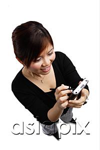 AsiaPix - Woman using PDA, high angle view