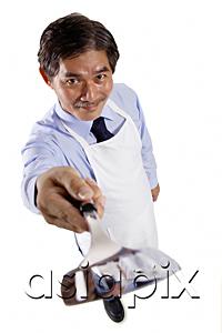 AsiaPix - Mature man wearing apron, pointing spatula at camera