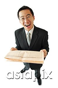AsiaPix - Businessman holding newspaper, laughing