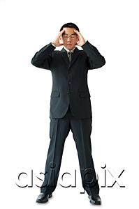 AsiaPix -  Businessman standing with hands on head