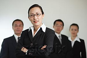 AsiaPix - Businesswoman with arms crossed, people in the background