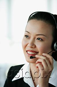 AsiaPix - Woman wearing headset, smiling, portrait