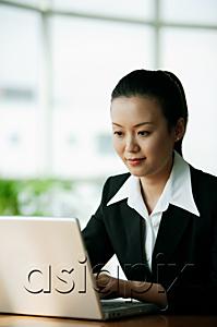 AsiaPix - Businesswoman using laptop