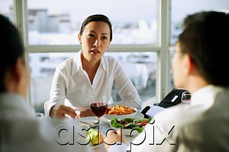 AsiaPix - Businesswoman facing other executives over lunch table