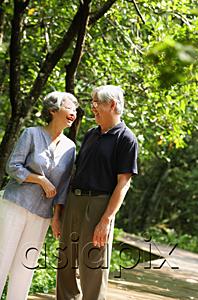 AsiaPix - Senior couple standing, facing each other, smiling