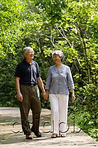 AsiaPix - Mature couple walking through park, holding hands