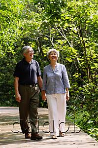 AsiaPix - Mature couple walking through park, holding hands, smiling