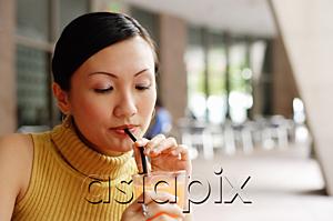 AsiaPix - Woman drinking from straw
