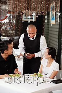 AsiaPix - Waiter talking to couple at restaurant