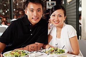 AsiaPix - Couple at restaurant, side by side, looking at camera