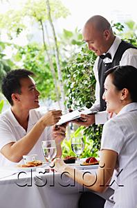 AsiaPix - Couple in restaurant, making payment to waiter