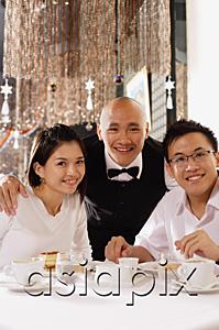AsiaPix - Waiter and customers at restaurant, looking at camera, smiling