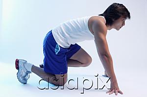 AsiaPix - Man kneeling at starting position, looking away