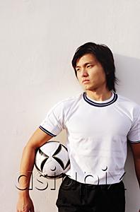 AsiaPix - Man holding soccer ball under arm