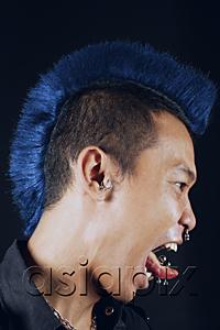 AsiaPix - Man with mohawk, side view, mouth open, sticking tongue out