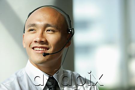 AsiaPix - Man with headset, smiling, looking away