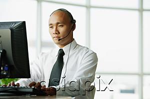 AsiaPix - Man with headset, using desktop PC
