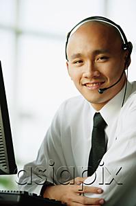 AsiaPix - Man with headset, smiling, looking at camera