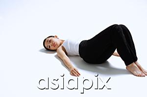 AsiaPix - Woman lying on back, knees up, arms outstretched