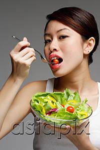 AsiaPix - Woman eating from bowl of salad
