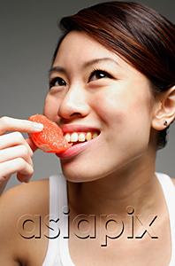 AsiaPix - Woman eating orange slice