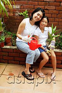 AsiaPix - Mother and daughter, sitting, looking at camera