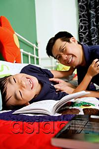 AsiaPix - Father tickling son on bed