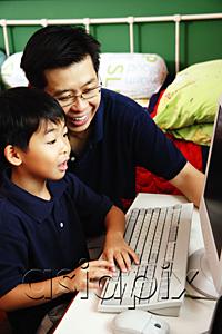 AsiaPix - Father and son using computer