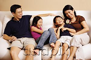 AsiaPix - Family of four on sofa, laughing