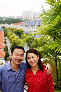 AsiaPix - Couple standing on balcony, smiling at camera, portrait