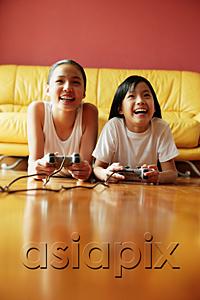 AsiaPix - Two sisters lying on floor playing video games
