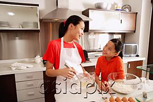 AsiaPix - Two sisters baking in kitchen