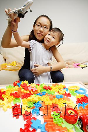 AsiaPix - Mother and daughter playing toy airplane