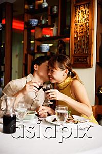 AsiaPix - Couple in Chinese restaurant, toasting with wine glasses, man kissing woman on cheek