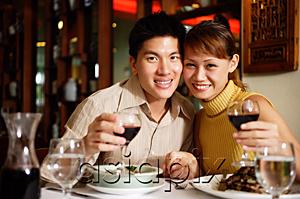 AsiaPix - Couple in restaurant, smiling at camera