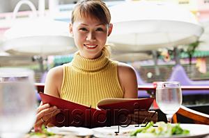 AsiaPix - Woman holding menu, looking at camera, smiling