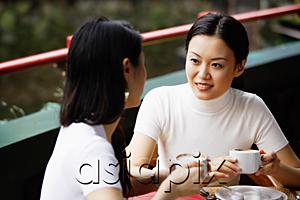 AsiaPix - Women in cafe, cups in hand