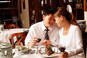 AsiaPix - Couple in restaurant, sitting face to face
