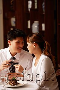 AsiaPix - Couple in restaurant, toasting with wine glasses