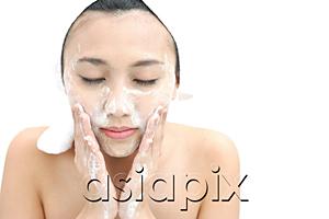 AsiaPix - Woman washing her face, eyes closed