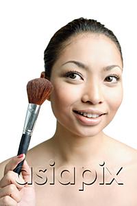 AsiaPix - Woman holding make-up brush