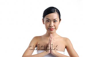 AsiaPix - Woman with hands together, looking at camera