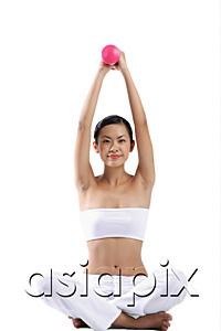 AsiaPix - Woman sitting on floor, lifting dumbbells, looking at camera