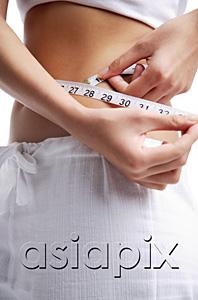 AsiaPix - Woman holding tape measure around waist