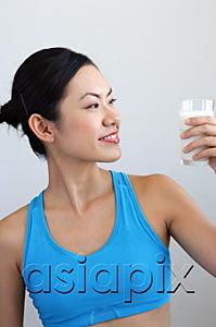AsiaPix - Woman looking at glass of milk