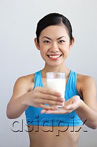 AsiaPix - Woman holding glass of milk