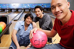 AsiaPix - Three men in bowling alley, looking at camera