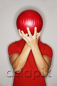 AsiaPix - Man holding bowling ball in front of his face