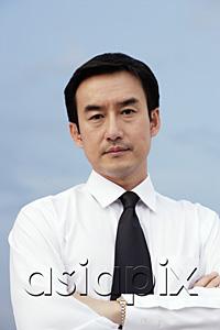 AsiaPix - Businessman with arms crossed, looking at camera, portrait